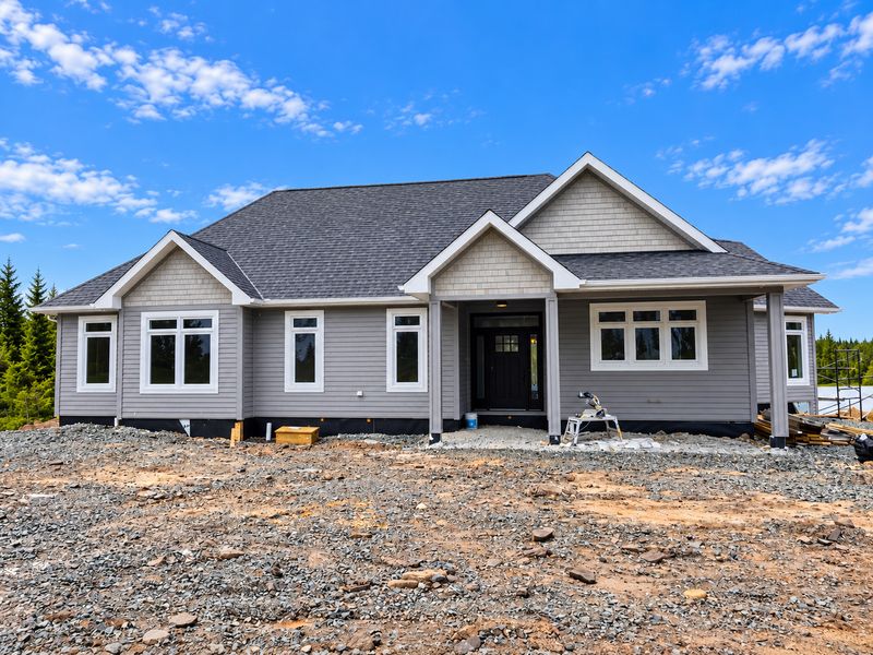 Front of a finished grey home with white trim, River Bourgeois