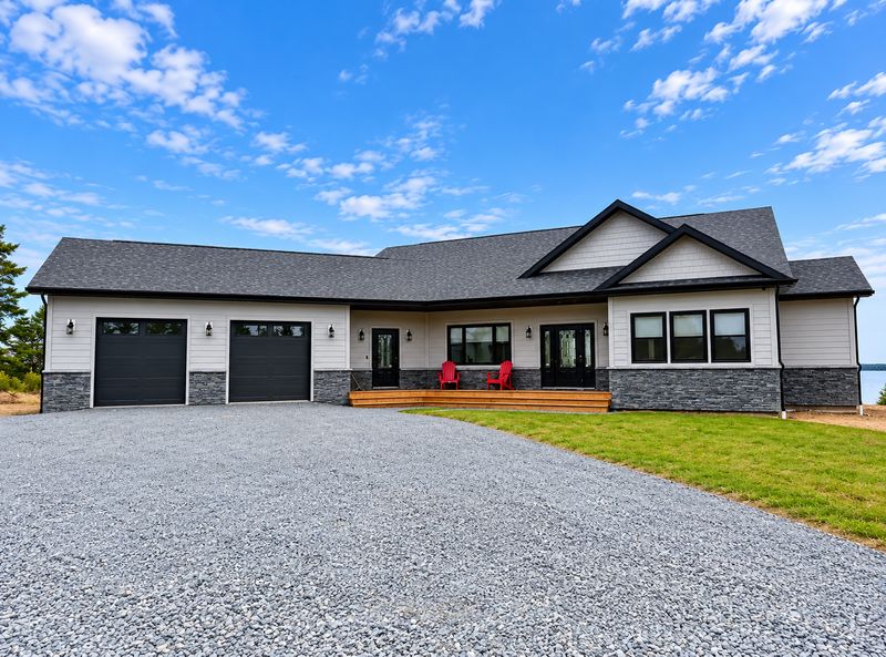 Front of a finished home with a two-car garage and a front deck, Whiteside